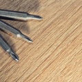 Screwdrive replaceable bits on a wooden background Royalty Free Stock Photo