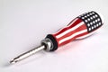 Screwdriver with an American flag color handle on a white Royalty Free Stock Photo