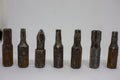 Old, rusty screwdriver bits on a white background. Close-up