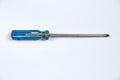 Close-up of a screwdriver with a blue handle on an isolated white background Royalty Free Stock Photo