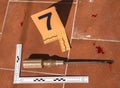 Screwdriver crime weapon on the ground, numbering in evidence Royalty Free Stock Photo