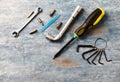 Screwdriver, hex keys, socket wrench and bits for a screwdriver on rustic wooden background. Royalty Free Stock Photo