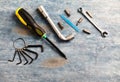 Screwdriver, hex keys, socket wrench and bits for a screwdriver on rustic wooden background. Royalty Free Stock Photo