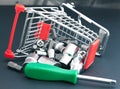 Screwdriver with interchangeable heads in toppled shopping cart