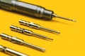 Screwdriver with replaceable metal bits on a yellow background Royalty Free Stock Photo