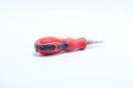 Red colored screwdriver often used by craftsmen on an isolated white background Royalty Free Stock Photo