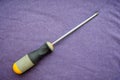 Screwdriver with a rubberized yellow-gray handle Royalty Free Stock Photo