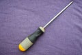 Screwdriver with a rubberized yellow-gray handle Royalty Free Stock Photo