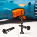 Screwdriver and screws lie on a sheet of drywall. The sheet is marked with a pencil. Square shot. Close-up Royalty Free Stock Photo