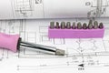Screwdriver and set of bits on the blueprint Royalty Free Stock Photo
