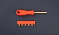 Screwdriver, socket wrench and set of replaceable bit, orange rubber handle on blue background Royalty Free Stock Photo