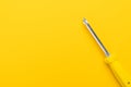 Screwdriver on yellow background Royalty Free Stock Photo