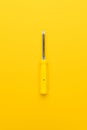 Screwdriver on yellow background Royalty Free Stock Photo