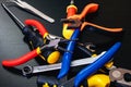 Screwdrivers and pliers, tools on wooden table