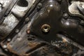 Screwed bolt at the bottom of the oil pan of a diesel engine with a new, copper washer, after pouring out old oil.
