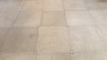 Screwed in grey tan floor tiles Royalty Free Stock Photo