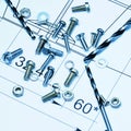 Screws and drill bits on drawing sheet Royalty Free Stock Photo