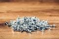 Screws fasteners hardware heap on wooden background Royalty Free Stock Photo