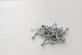 Screws on metal a heap lie on a gray background Royalty Free Stock Photo