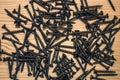 Screws nad nails on wooden background. Royalty Free Stock Photo