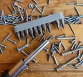 Screws, screwdriver and set of bits (heads) on wood background Royalty Free Stock Photo