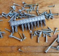 Screws and set of bits (heads) on wood background Royalty Free Stock Photo