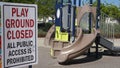 Scribbled notes of protest on a closed playground sign during Covid-19 shutdown.