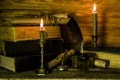 Scroll documents, two burning candles, an inkwell and old books are on the table Royalty Free Stock Photo