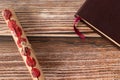 Scroll with seven seals and closed holy bible book on wooden table with copy space, top view