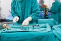 Scrub nurse preparing medical instruments for operation