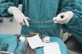 Scrub nurse preparing medical instruments for operation