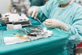 Scrub nurse preparing medical instruments for operation