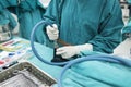 Scrub nurse preparing medical instruments for surgery