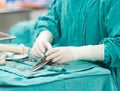 Scrub nurse preparing tools for operation