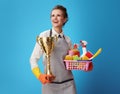 Scrubwoman with a basket with cleansers, brushes and goblet