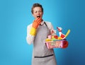 Scrubwoman with basket with cleansers and brushes yawning