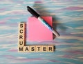 Scrum Master in letters with pink notes and blue background
