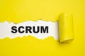 scrum. text on white paper over torn paper background