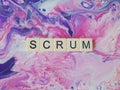 Scrum word on flowing background of purple and pink