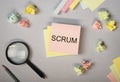 Scrum word on paper note on office desk, flat lay. Concept of methods in management