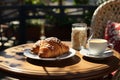 Delicious croissant and cup of coffee on a dark background