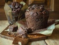 Scrumptious Home Baked Chocolate Chips Muffins in Brown Paper on Wooden Cutting Board. Rustic Kitchen