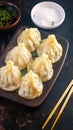 Scrumptious manti dumplings arranged enticingly on dark background