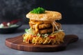 Scrumptious Ramen Burger with Seafood Patty and Spicy Sauce Served on a Wooden Plank