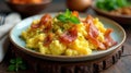 Scrumptious scrambled eggs with crispy bacon garnished with fresh herbs, a delightful breakfast or brunch dish presented on a Royalty Free Stock Photo