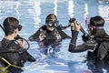 Scuba dive training in the pool with a smiling instructor Royalty Free Stock Photo