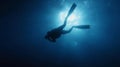 Scuba diver in the blue water descending in to the depth Royalty Free Stock Photo