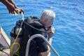 Scuba diver before diving. Diving lesson in open water. Male in scuba diving suit is preparing to dive into deep sea. Royalty Free Stock Photo