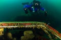 SCUBA diver in a drysuit and rebreather underwater in a cold, dark, murky quarry Royalty Free Stock Photo