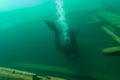 SCUBA diver entering the cabin trunk of wooden schooner shipwreck Royalty Free Stock Photo